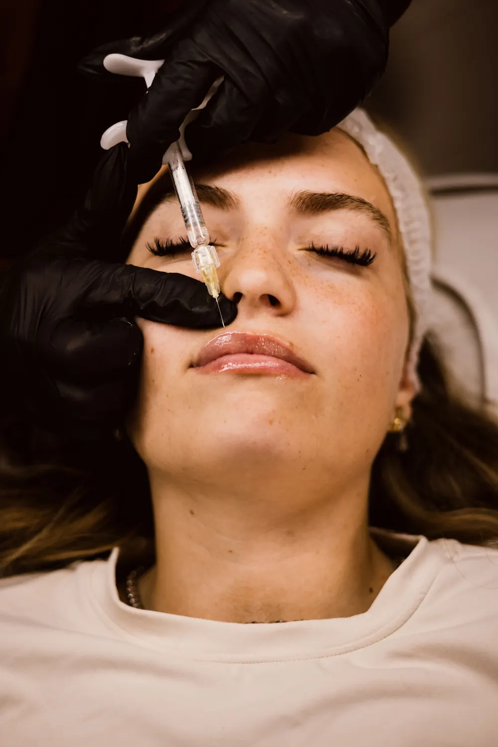 Aesthetics practitioner carrying out a precise facial treatment