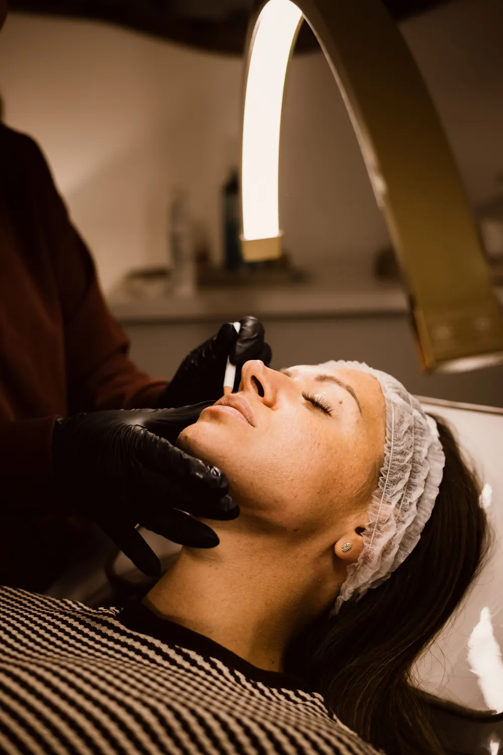 Dermaplaning facial treatment in a modern beauty clinic